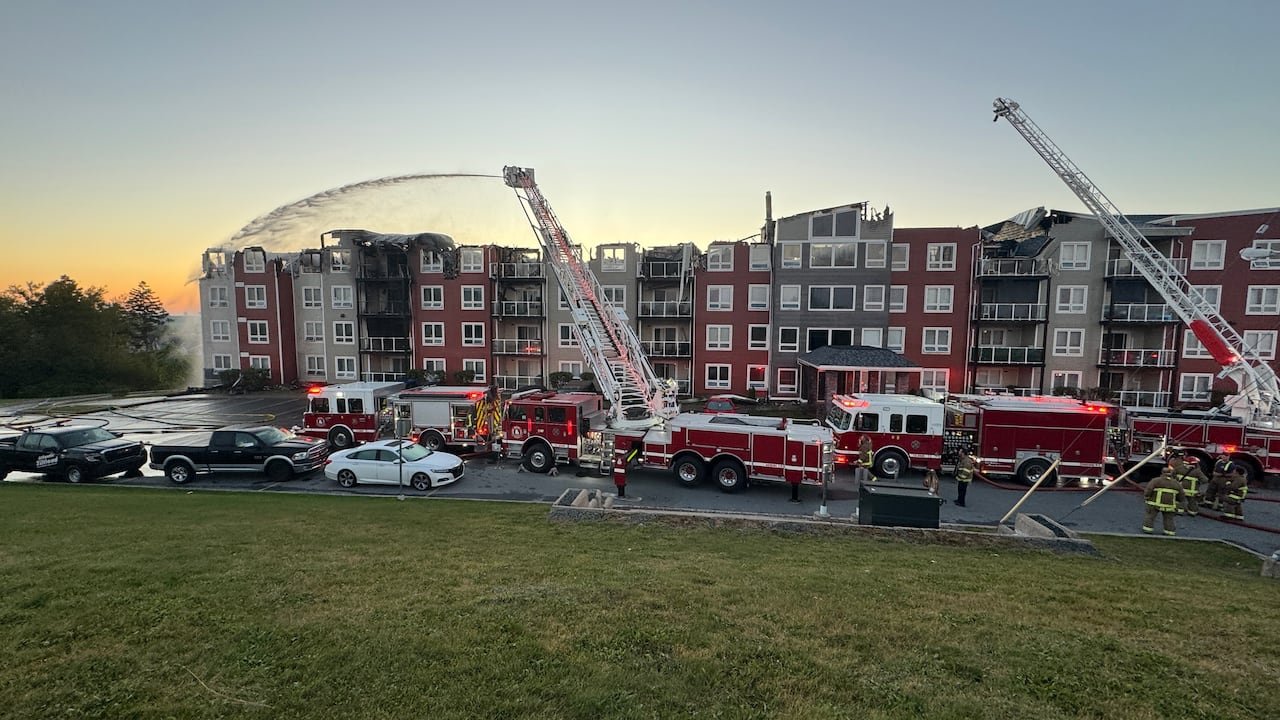 default-201 Fire trucks are shown in front of an apartment building.
