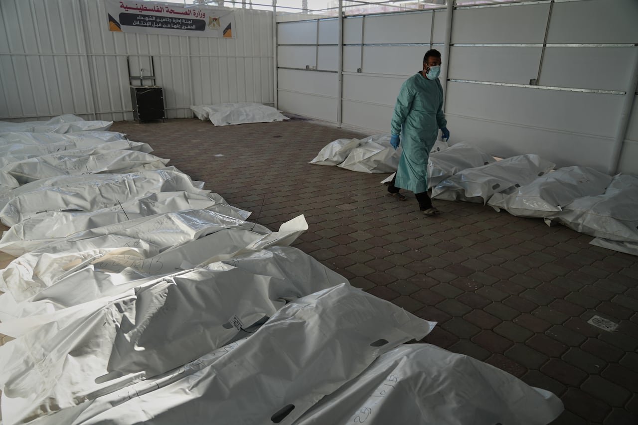 default-1 Bodies lie in plastic bags on the floor.