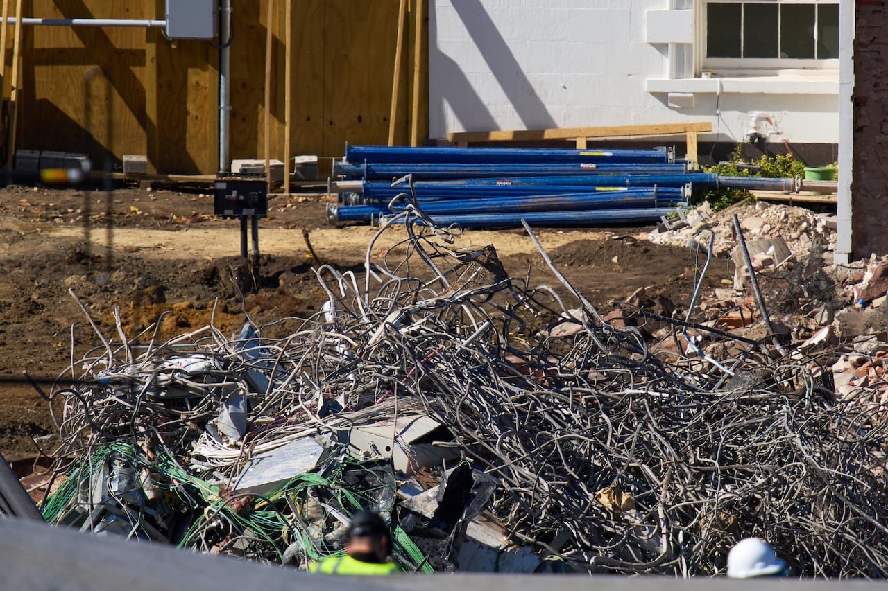 Wires and poles and other debris are shown at ground level.