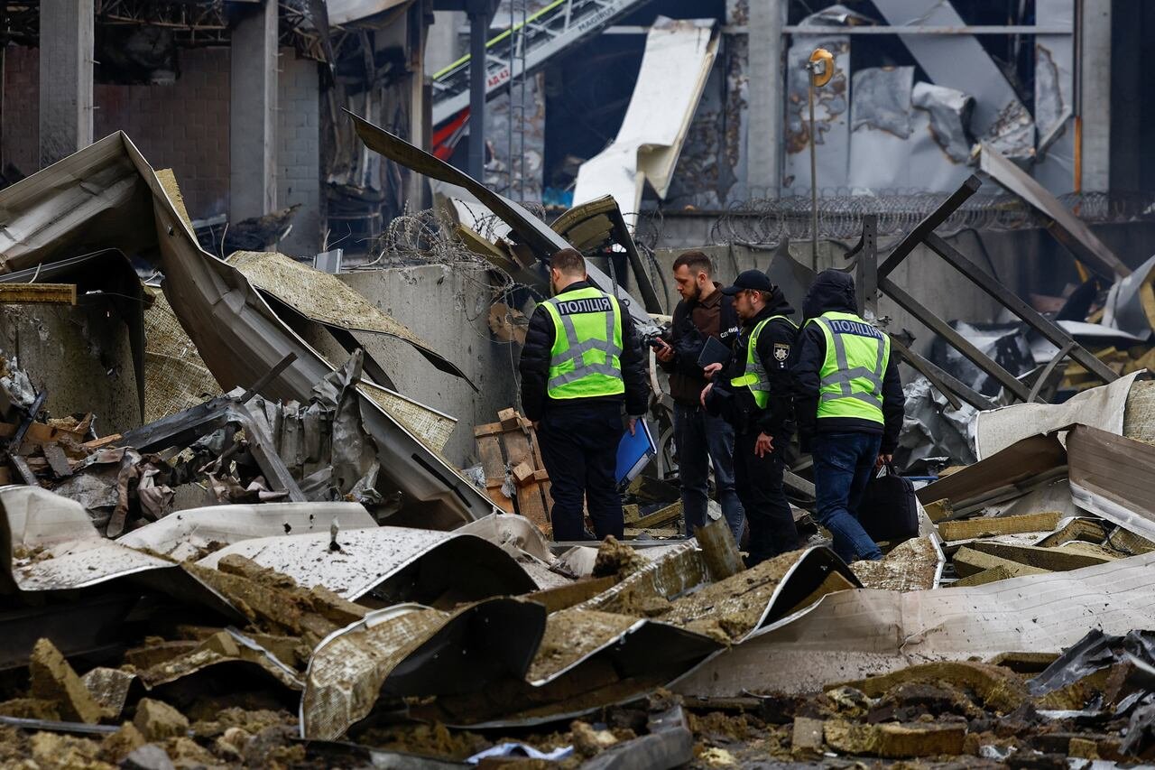 default-493 Police investigators stand on top of rubble.