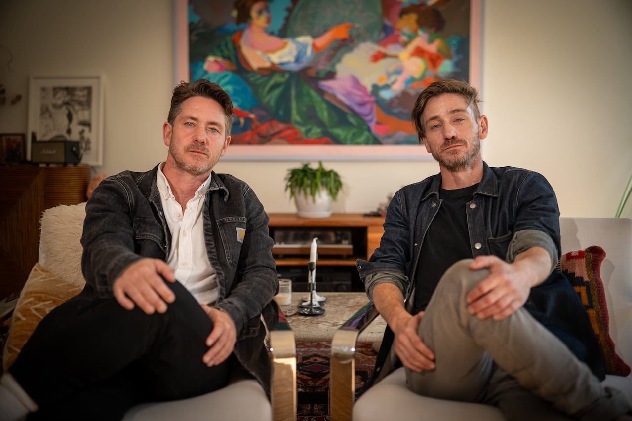 two men sit on chairs